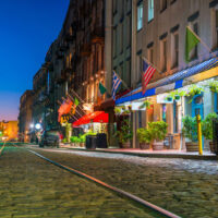 Shops Along Cobblestone Street in Savannah, GA at Twilight