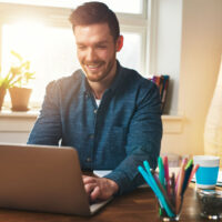 Motivated employee happily working from home